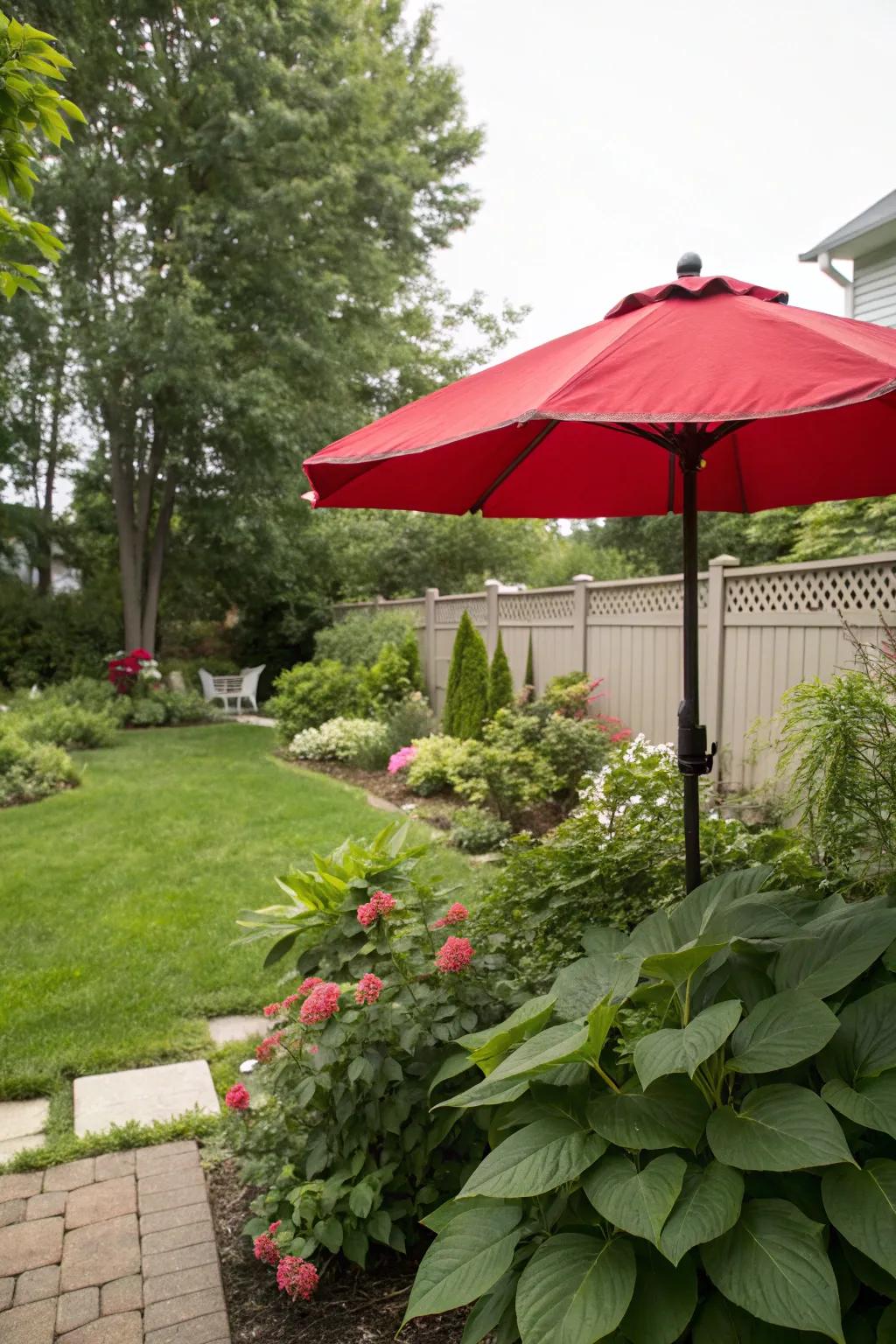 A backyard with a vibrant red sunshade for a burst of color.