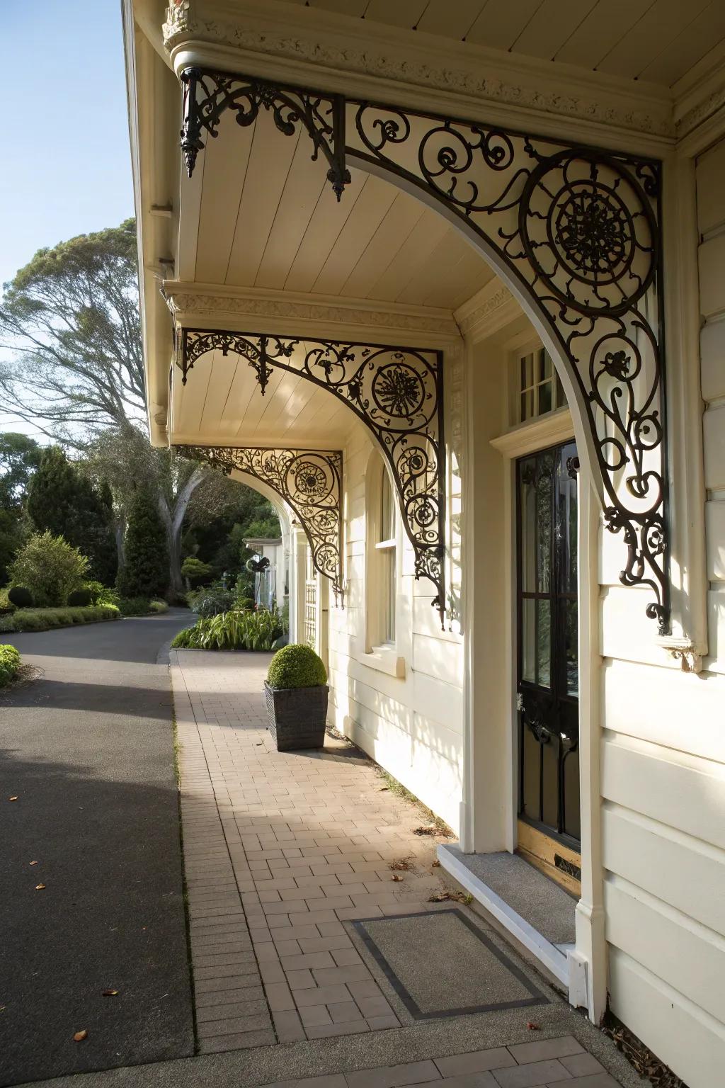 An entrance with stylish holders supporting a shelter.