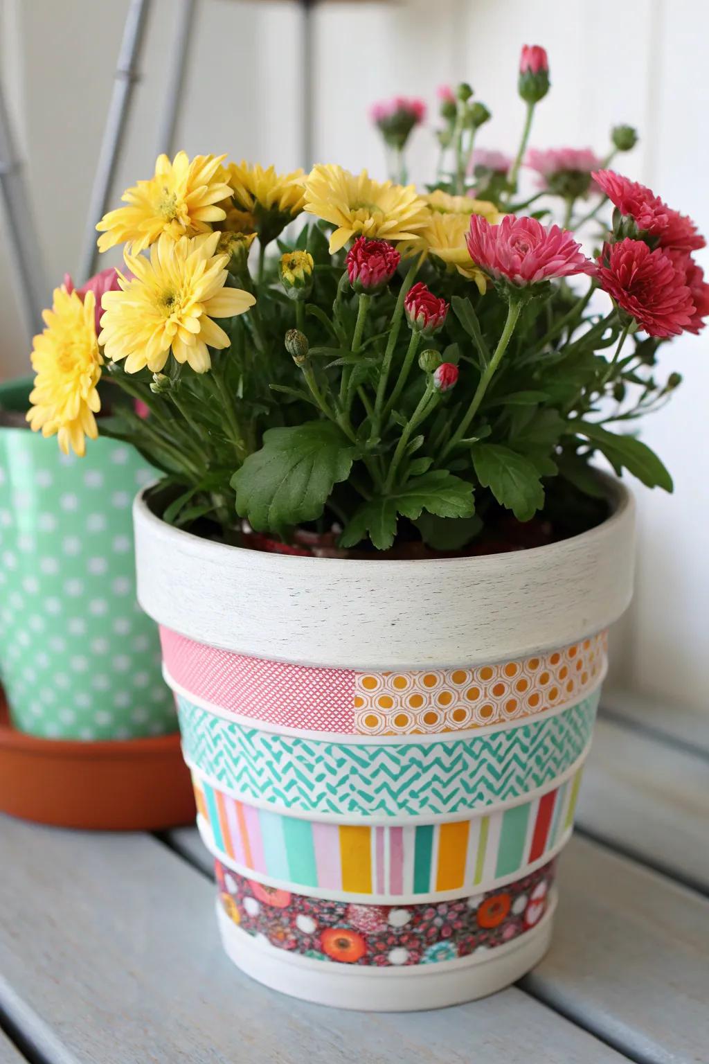 A flower container elevated with vibrant adhesive strip artwork.