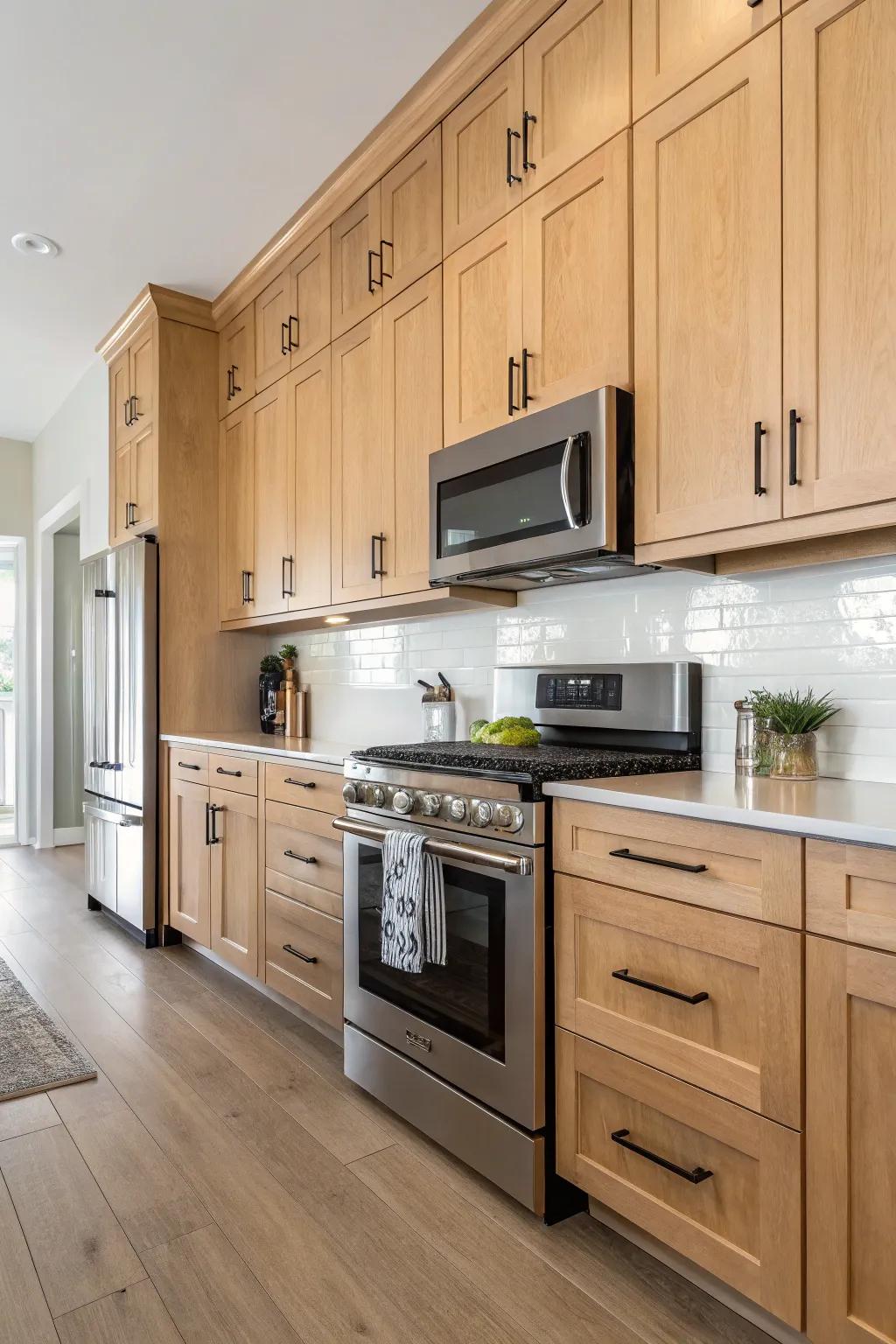 Sleek hardware adds a modern touch to light maple cabinets.