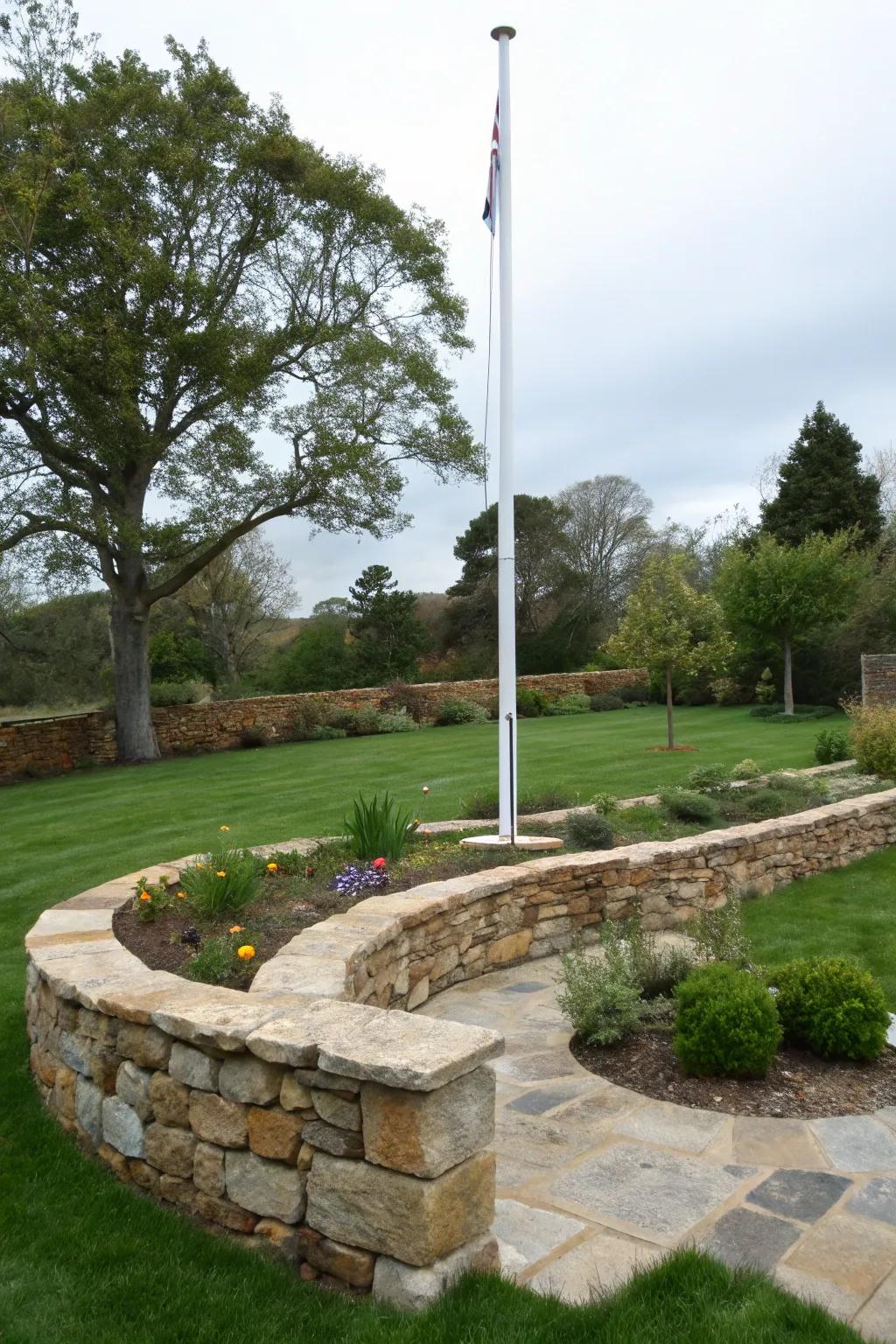 Elegant stone borders frame a flagpole, enhancing its presence.