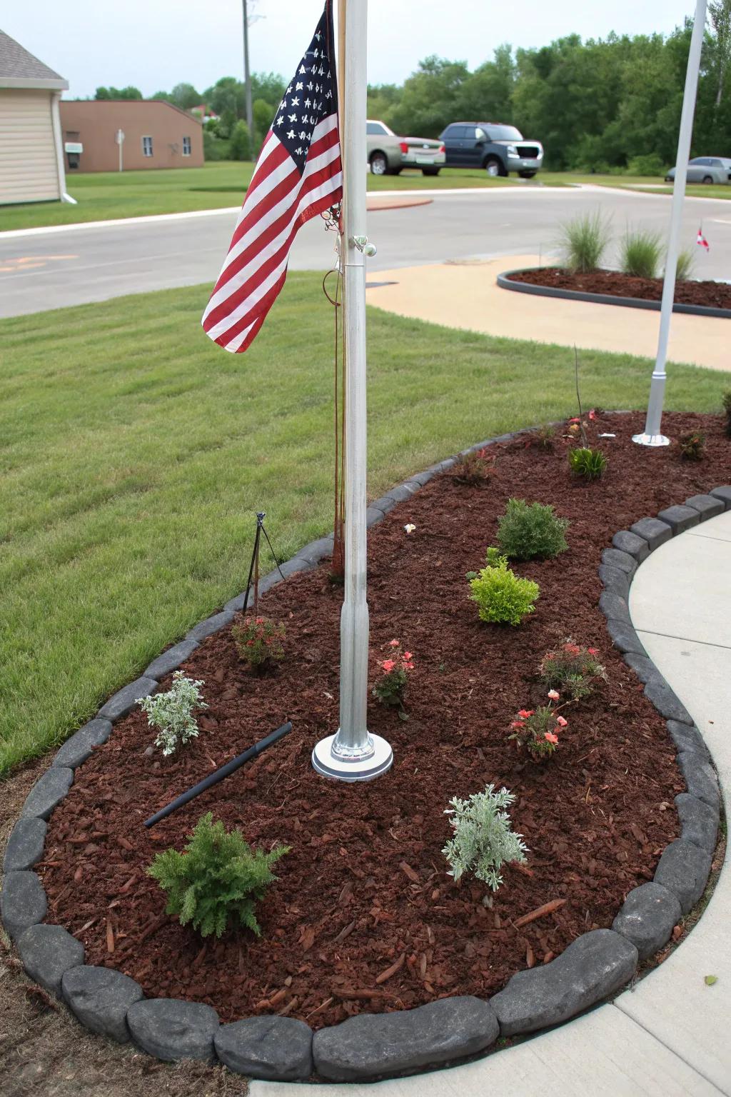 Decorative mulch adds a clean, finished look to a flagpole landscape.