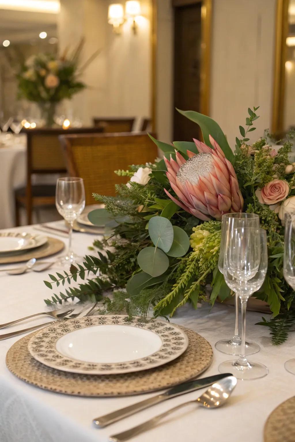 A mix of flowers and greenery creates a stunning table centerpiece.