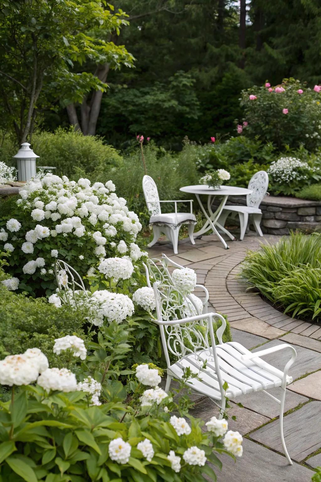White garden furniture complements the tranquil aesthetic of a white garden.
