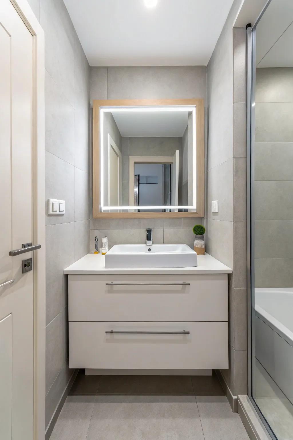 A compact contemporary bathroom displays an elevated vanity to maximize area.