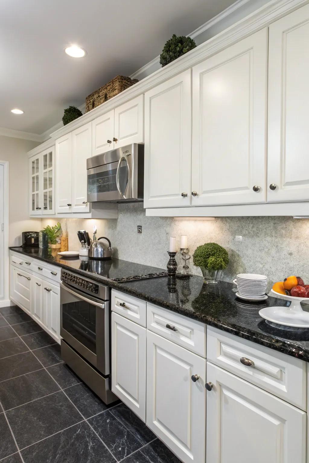 Dark countertops create a striking visual contrast against white cabinets.