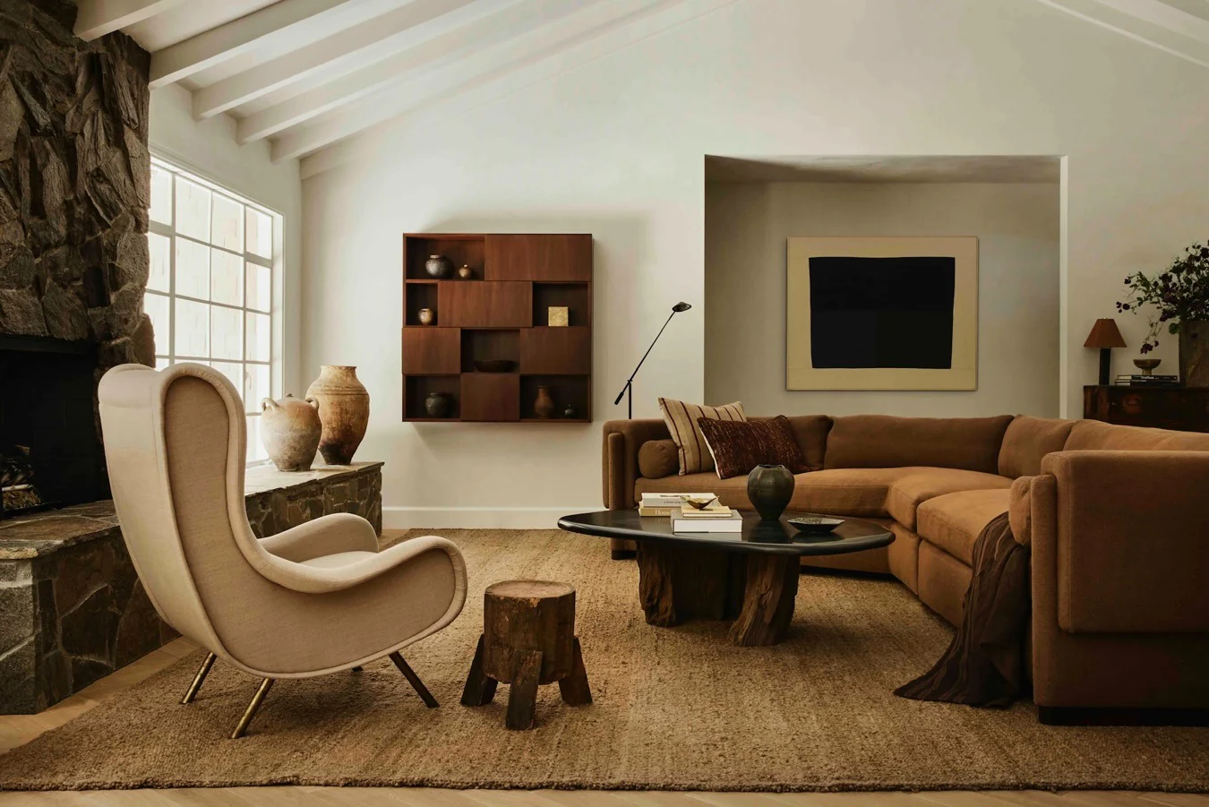 6. Saddle Brown Sectional with Sculptural Contrast (Brown Furniture Living Room Ideas)