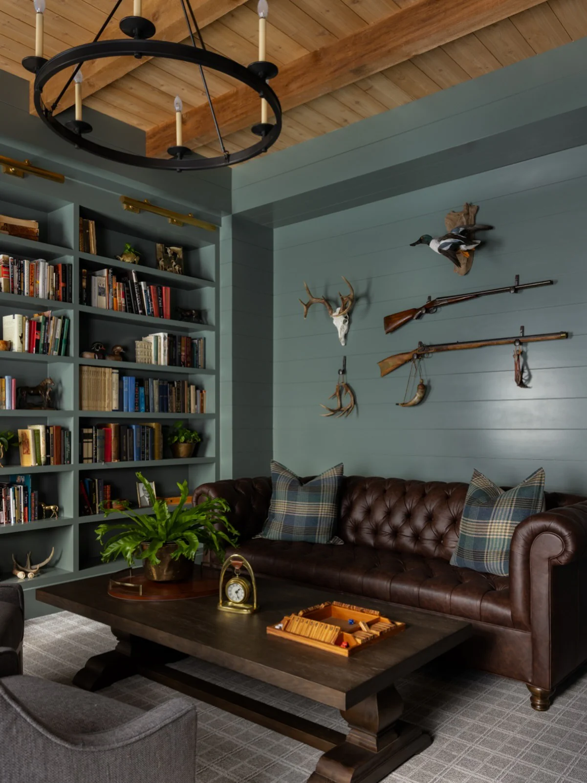10. Traditional Brown Leather with Library-Inspired Walls (Brown Furniture Living Room Ideas)
