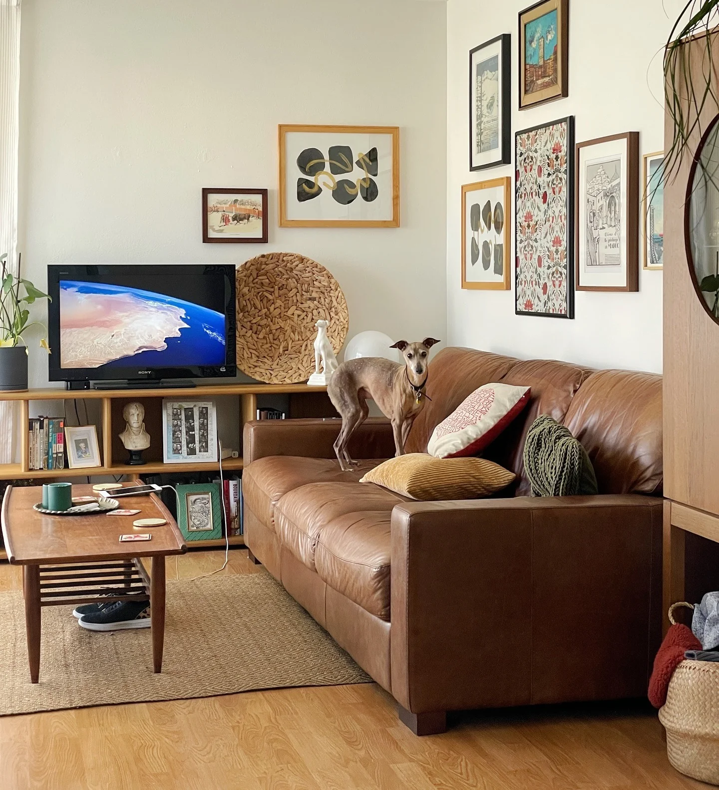 12. Cognac Leather Sofa with Eclectic Gallery Wall (Brown Furniture Living Room Ideas)