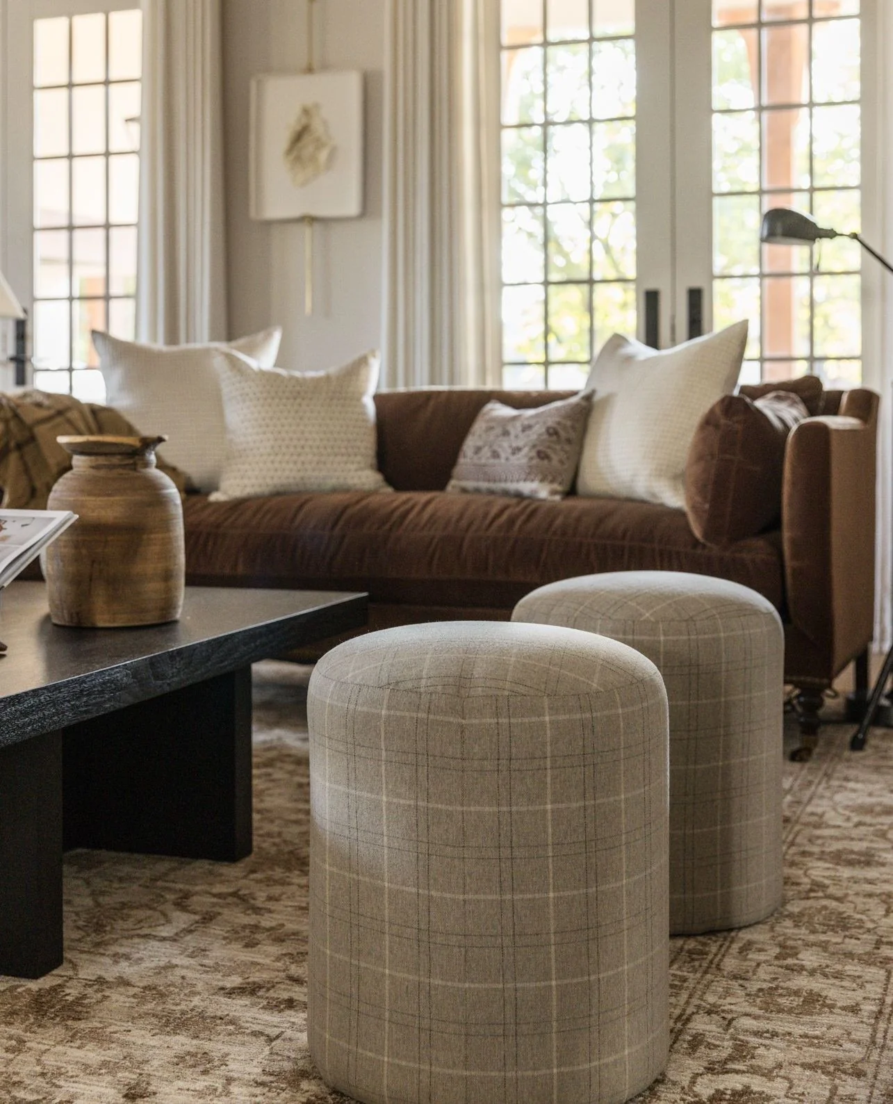 7. Tailored Brown Sofa with Soft Plaid Ottomans (Brown Furniture Living Room Ideas)