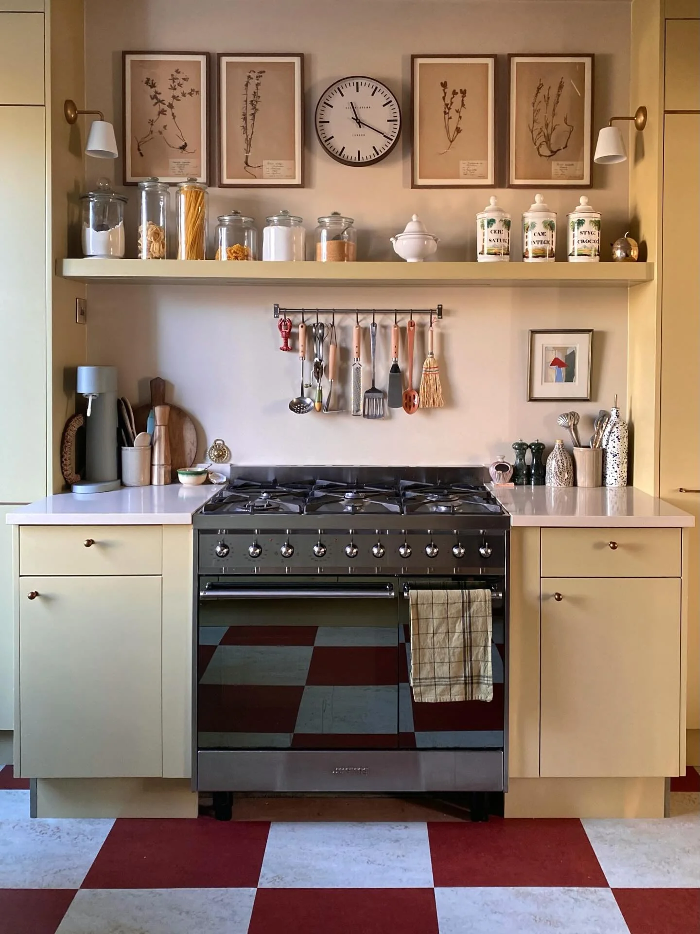 2. Buttercream Cabinets with Vintage Red Checkerboard Flooring (Small Space Kitchen Ideas)