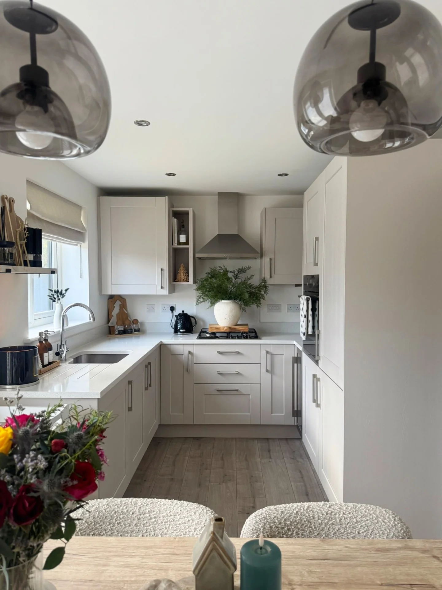 14. Warm White Cabinets with Smoked Glass Pendants (Small Space Kitchen Ideas)