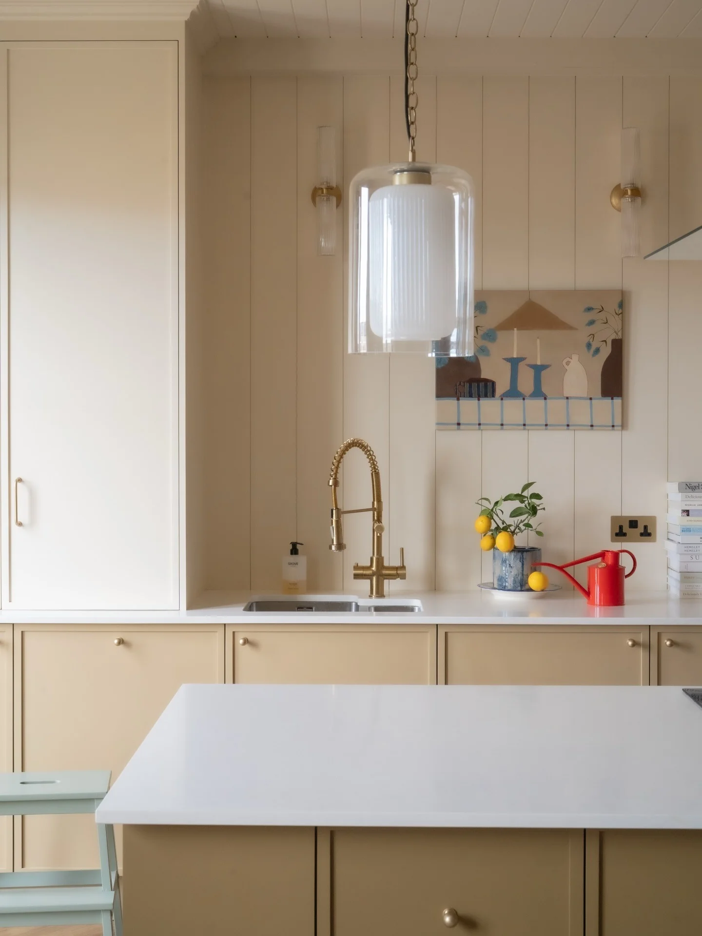 10. Warm Beige Cabinets with Statement Lighting (Small Space Kitchen Ideas)