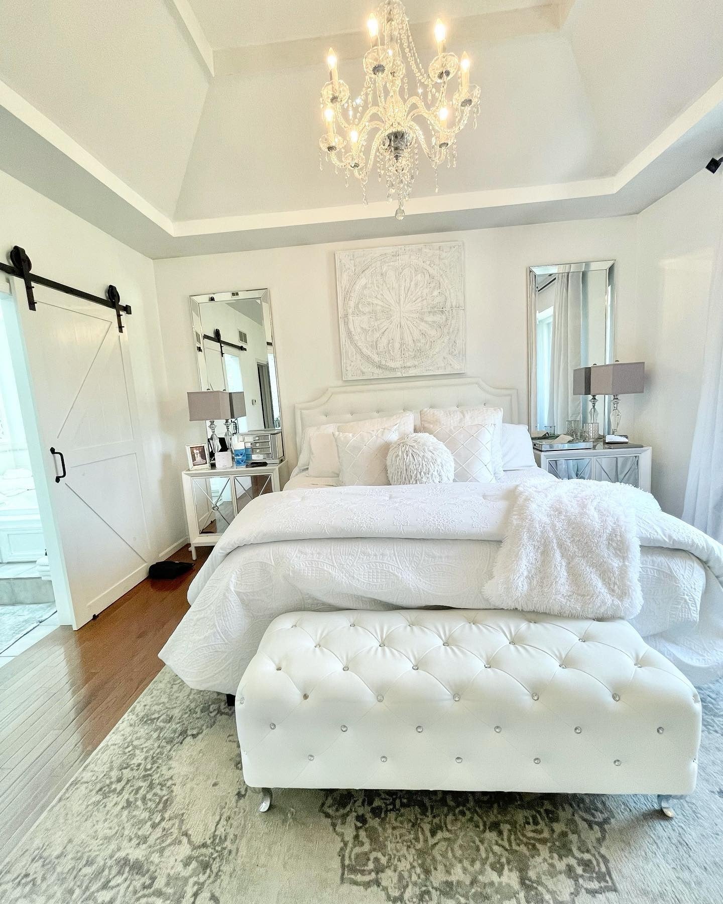 8. Elegant White Bedroom with Crystal Lighting and Tufted Bench (All White Bedroom Ideas)