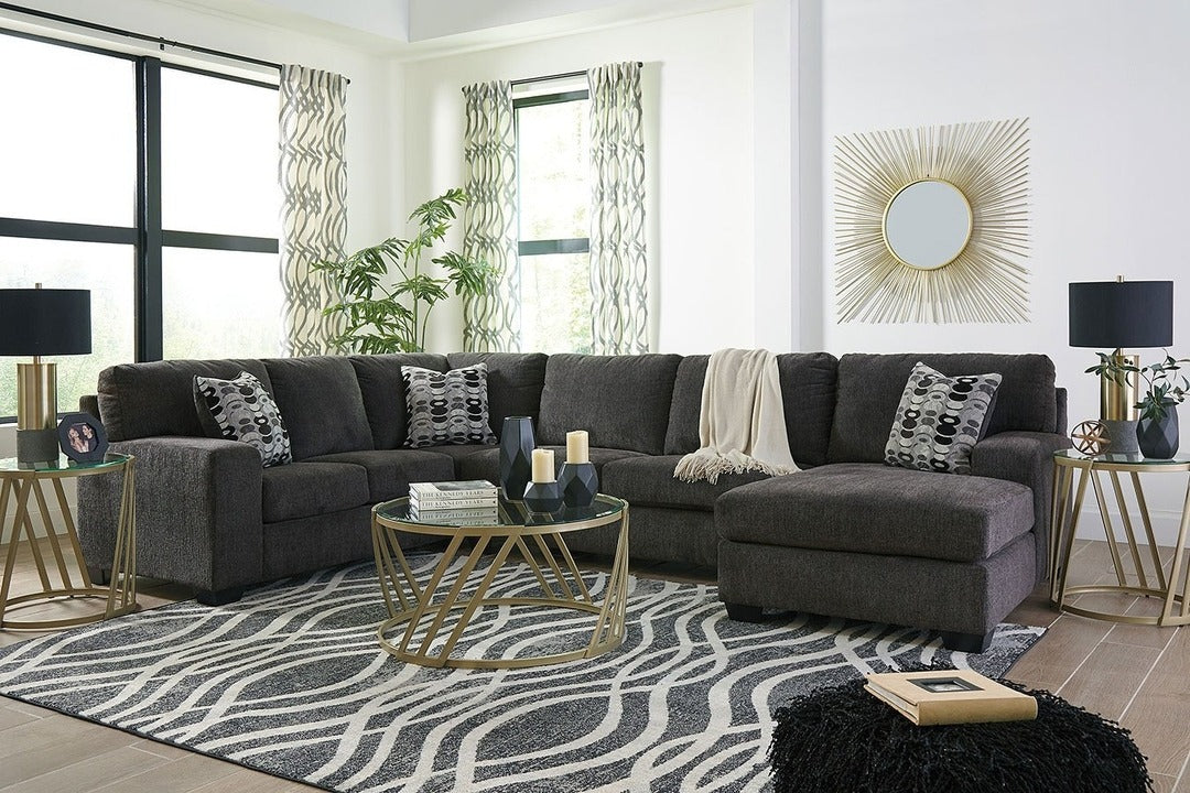 2. Charcoal Gray Sectional with Gold Accent Glam (Gray Furniture Living Room Ideas)