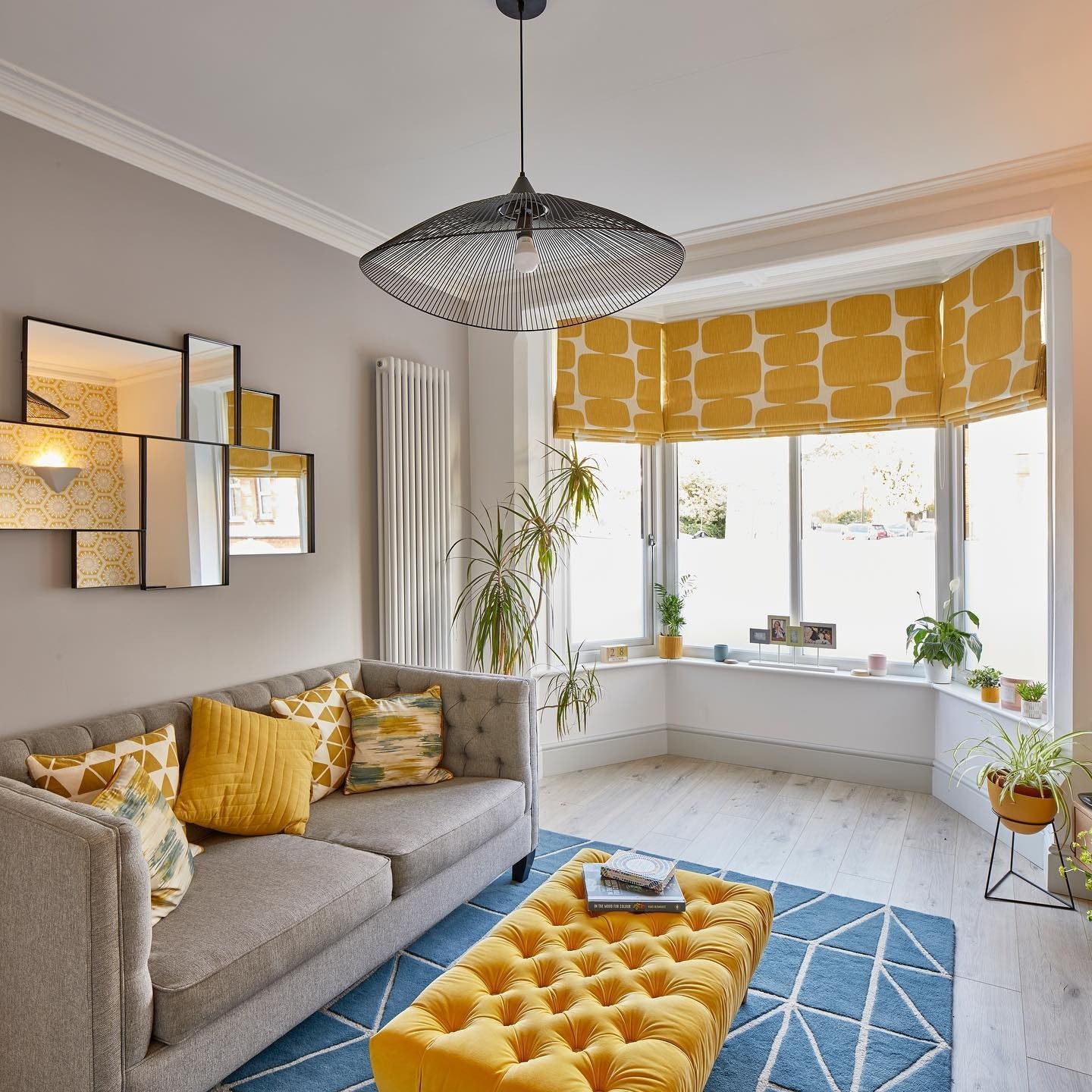 10. Soft Gray Sofa with Mustard Ottoman Feature (Yellow and Gray Living Room Ideas)