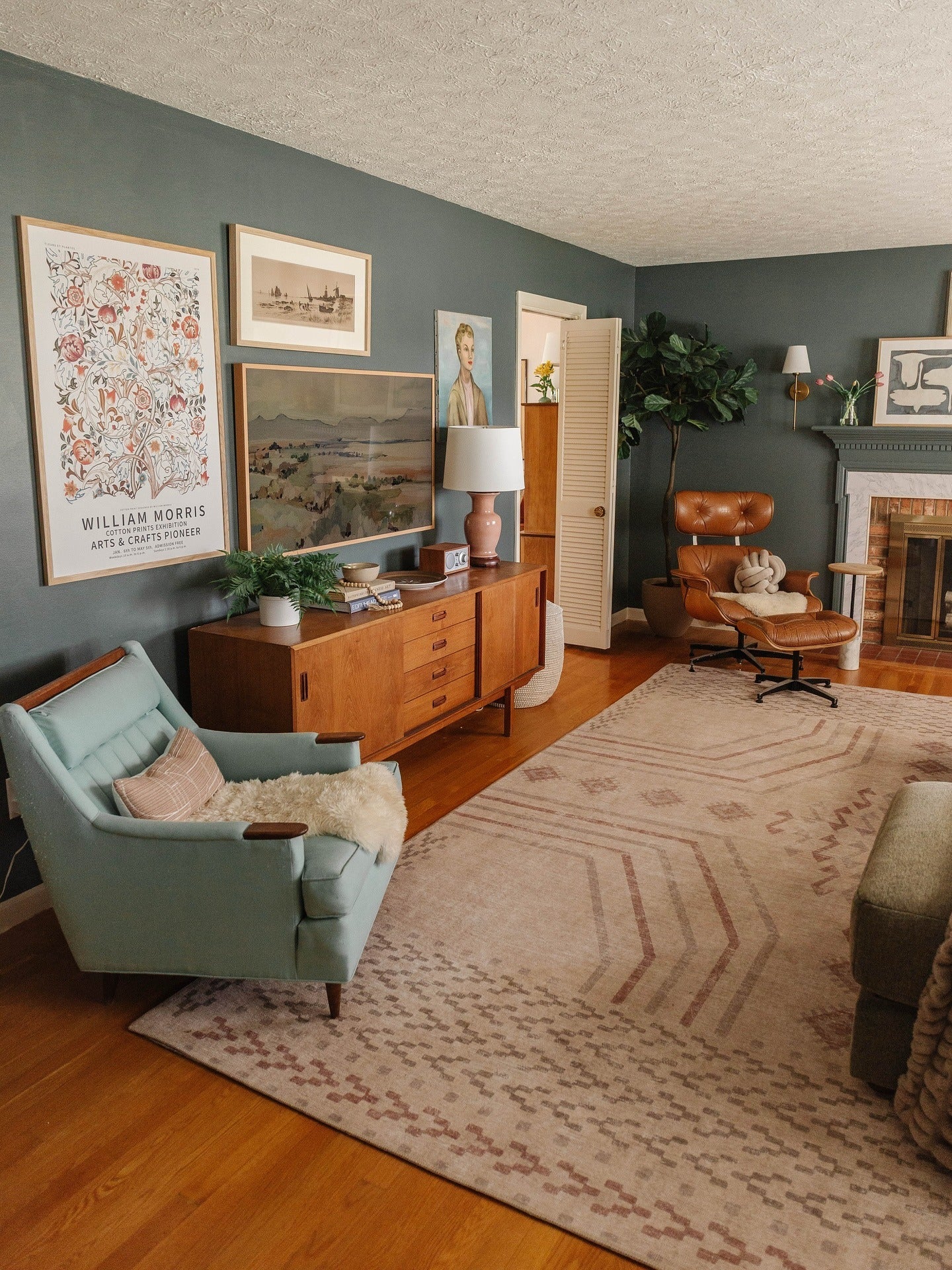 2. Forest Green Gallery Wall with Camel Leather Accents (Jungle Living Room Ideas)