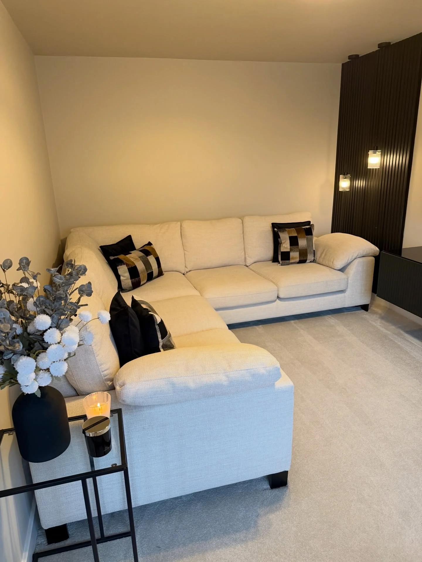 3. Minimal Cream Wall with Sculptural Lighting (Empty Wall Ideas for Living Room)