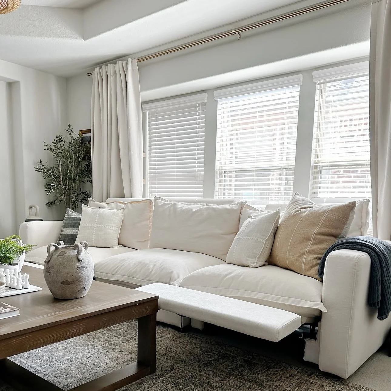 5. Bright Neutral Wall with Framed Architectural Detail (Empty Wall Ideas for Living Room)