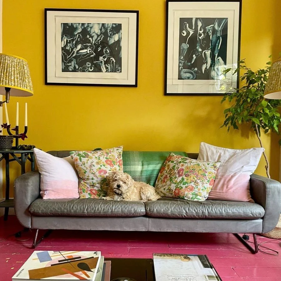 4. Golden Yellow Living Room with Art-Focused Styling (Yellow Walls Living Room Ideas)