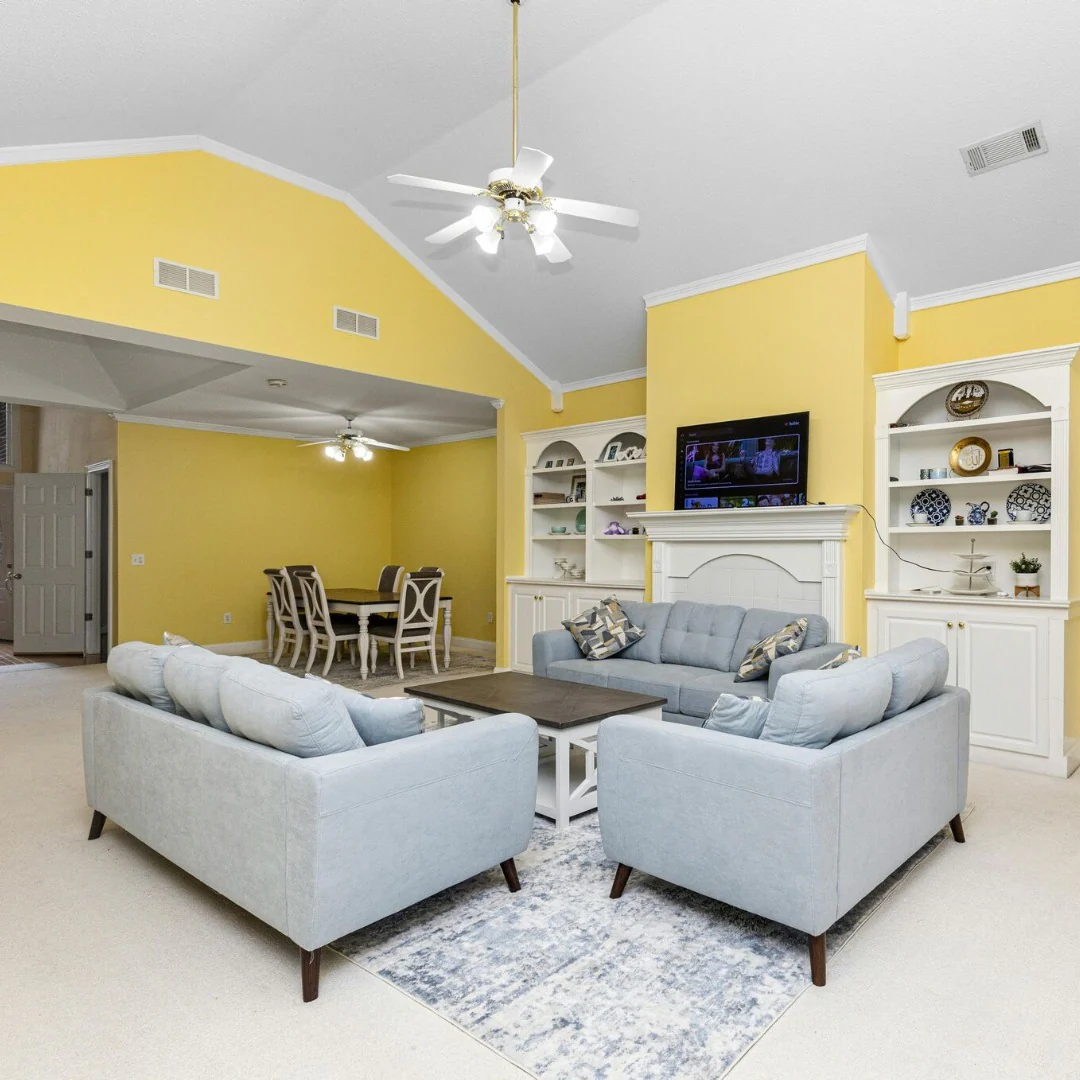 3. Soft Yellow Open-Plan Living Room with Classic Balance (Yellow Walls Living Room Ideas)