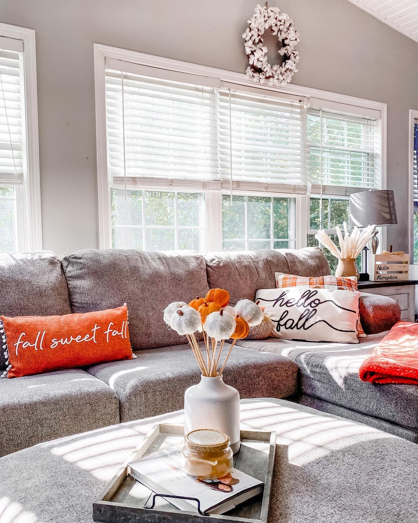 4. Cozy Sectional Styling in Gray and Burnt Orange (Fall Living Room Decorating Ideas)
