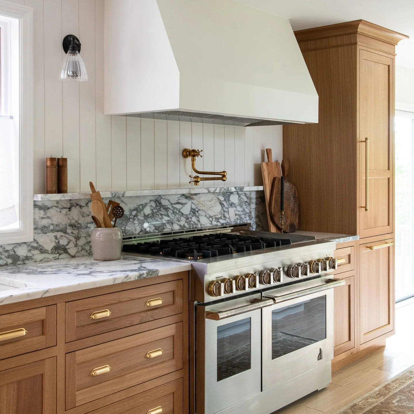 7. European Transitional Kitchen with Warm Wood and Marble Backsplash (European Kitchen Ideas)
