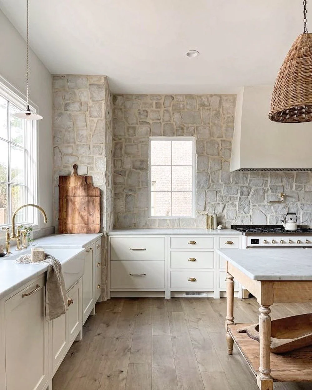 15. European Farmhouse Kitchen with Stone Walls and Warm Wood Island (European Kitchen Ideas)