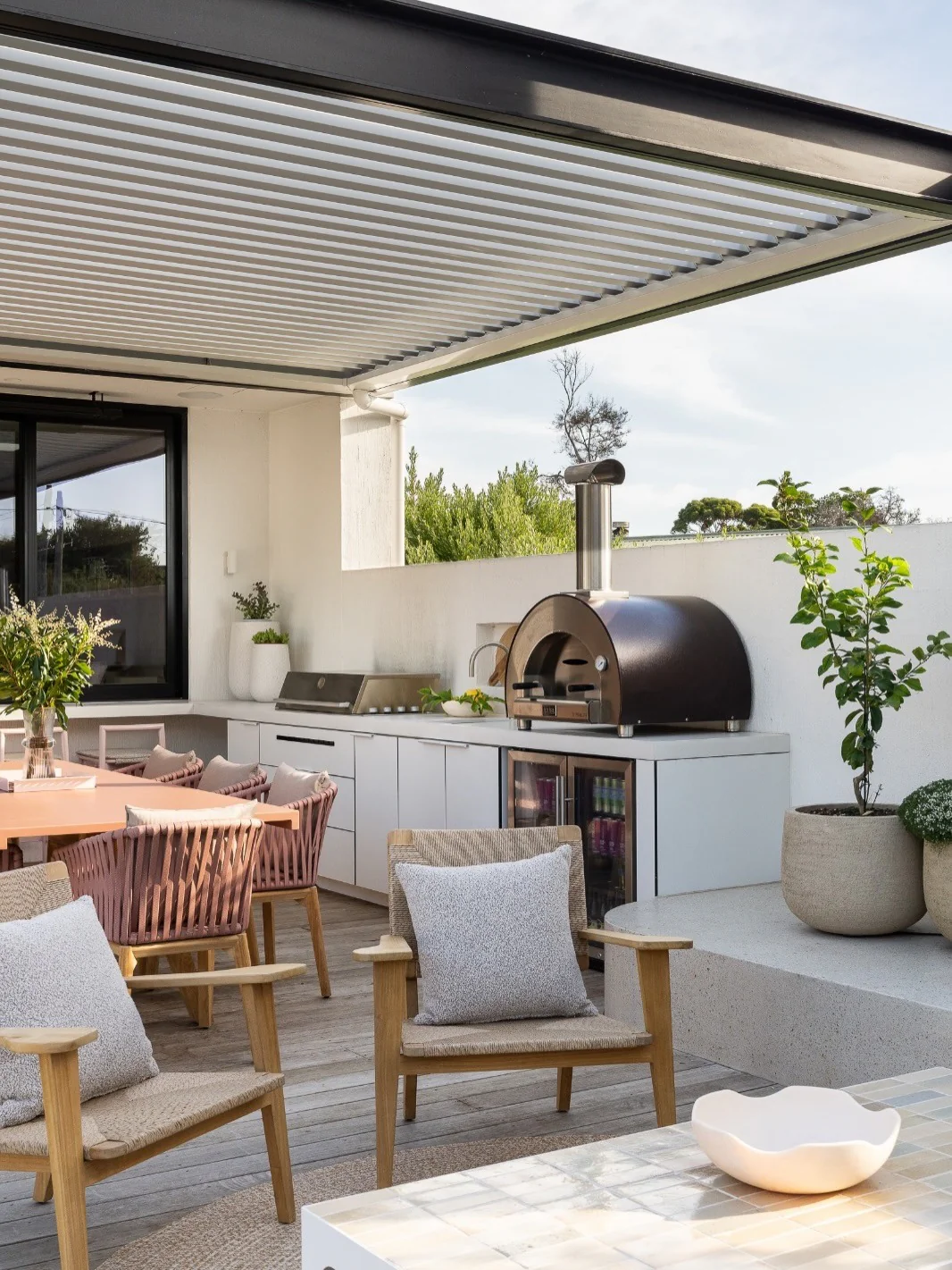 11. Modern Covered Outdoor Kitchen in Crisp White & Warm Wood (Small Outdoor Kitchen Ideas)