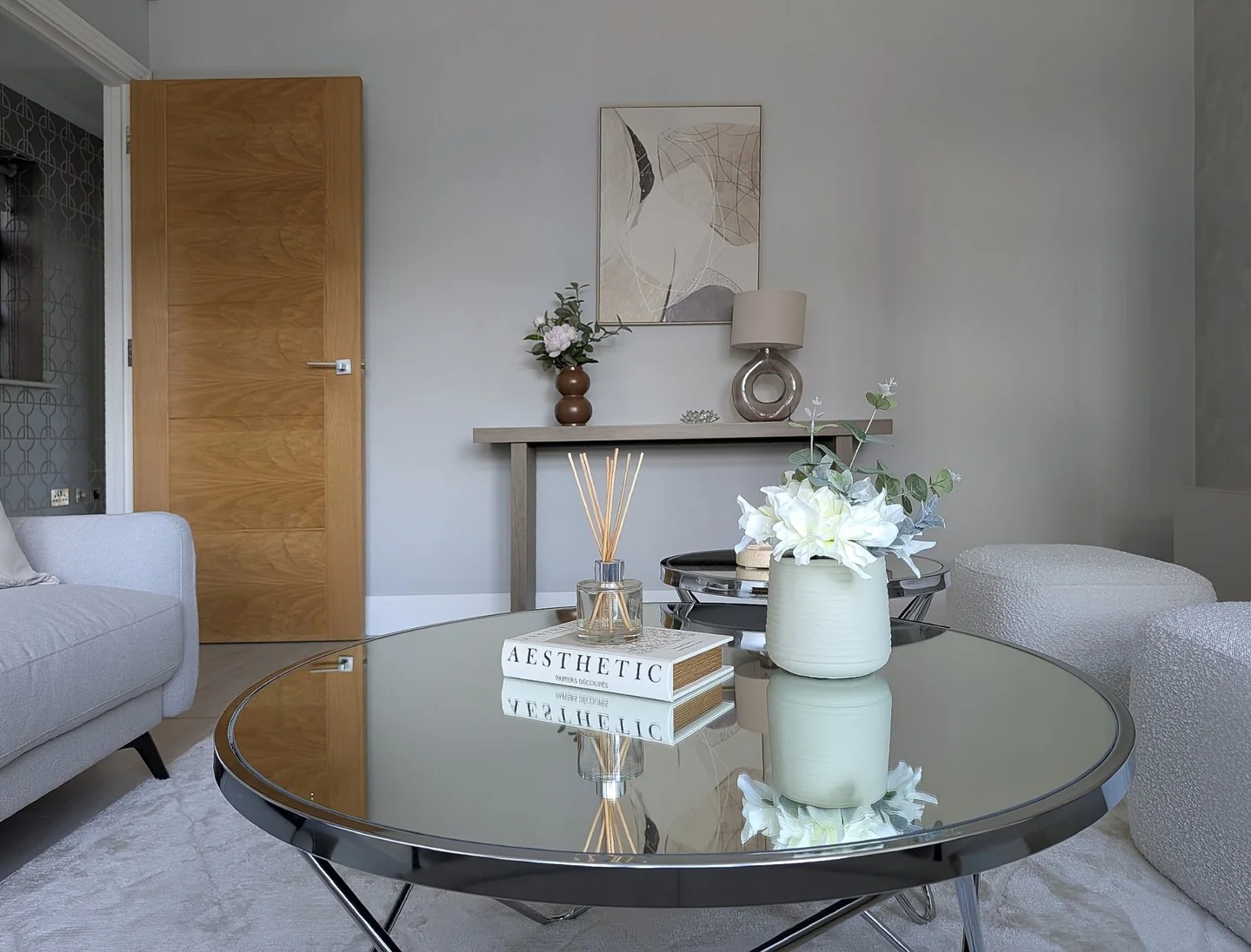 4. Light Grey Minimal Living Room with Glass & Sculptural Decor (Grey Walls Living Room Ideas)