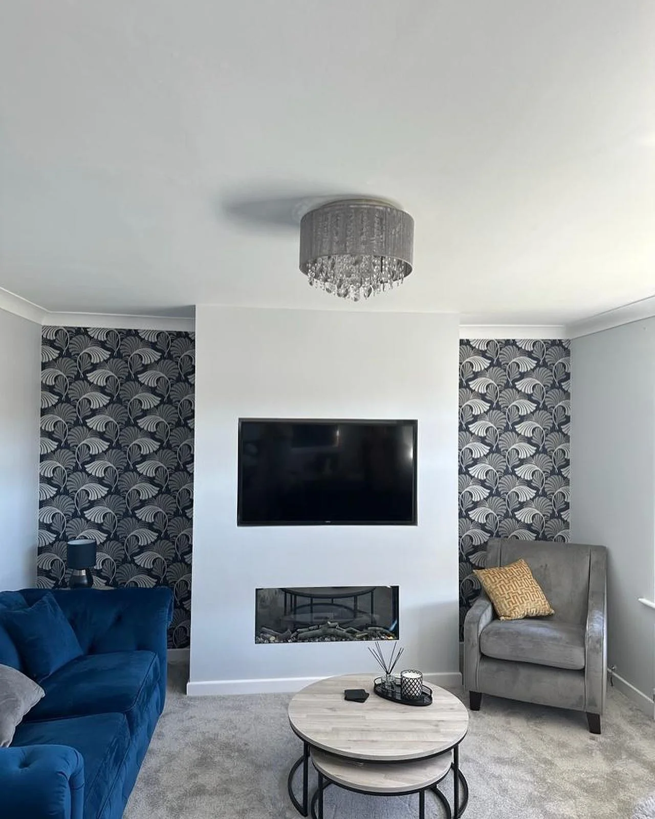 7. Grey Feature Wall with Wallpaper Panels & Moody Blue Seating (Grey Walls Living Room Ideas)