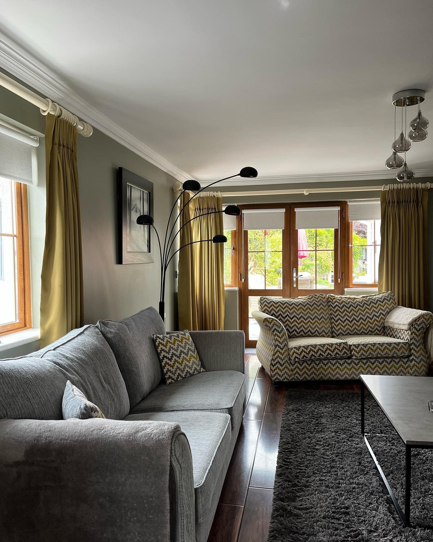 3. Grey Walls with Olive Drapes for a Rich, Classic Contrast (Grey Walls Living Room Ideas)
