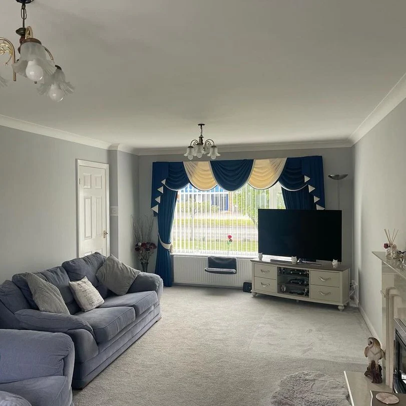 6. Grey Walls with Blue Drapes for a Bold, Traditional Statement (Grey Walls Living Room Ideas)