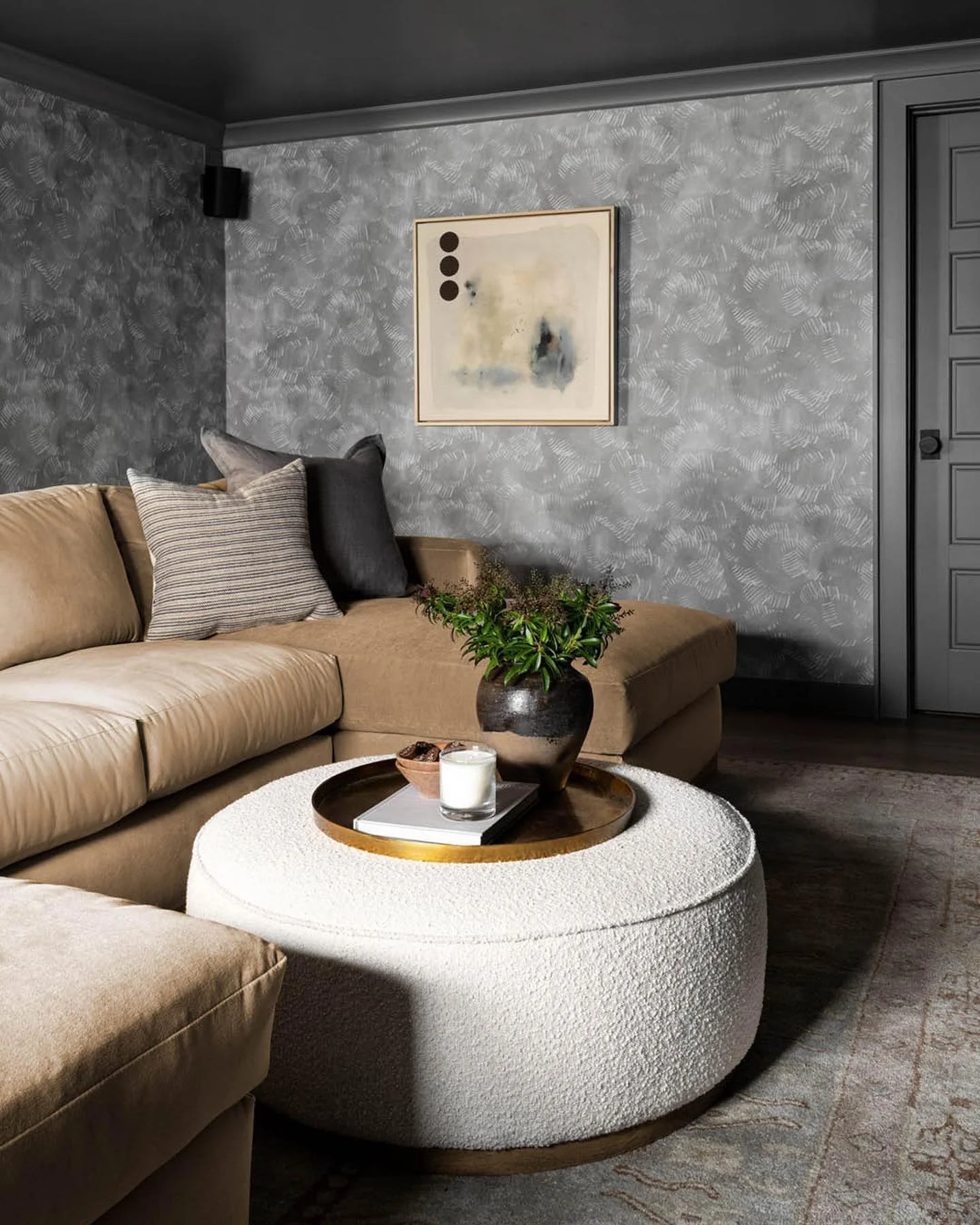 10. Moody Grey Textured Walls with Camel Seating & Bouclé Ottoman (Grey Walls Living Room Ideas)