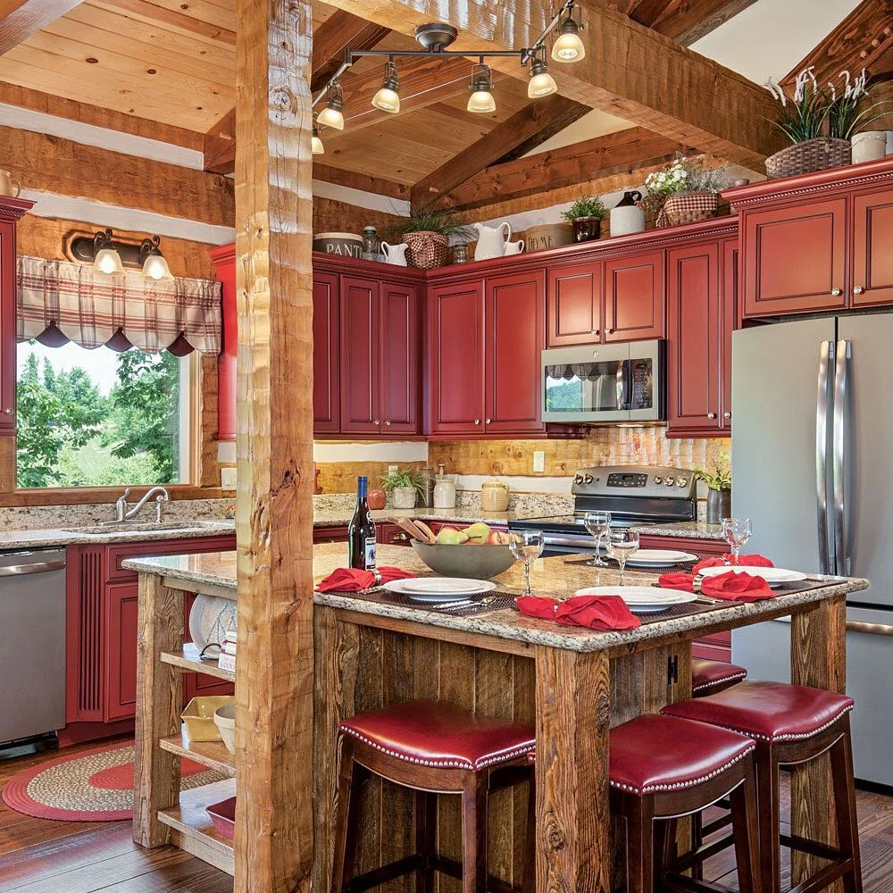 6. Cozy Log Kitchen with Red Cabinetry and Granite Tops (Log House Kitchen Ideas)