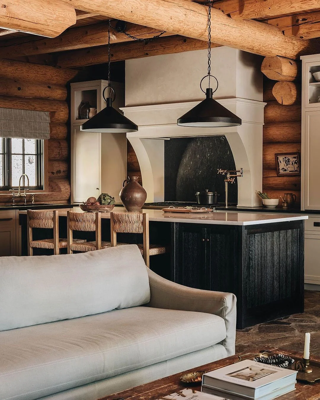 9. Modern Rustic Log Kitchen with Black and Cream Contrast (Log House Kitchen Ideas)