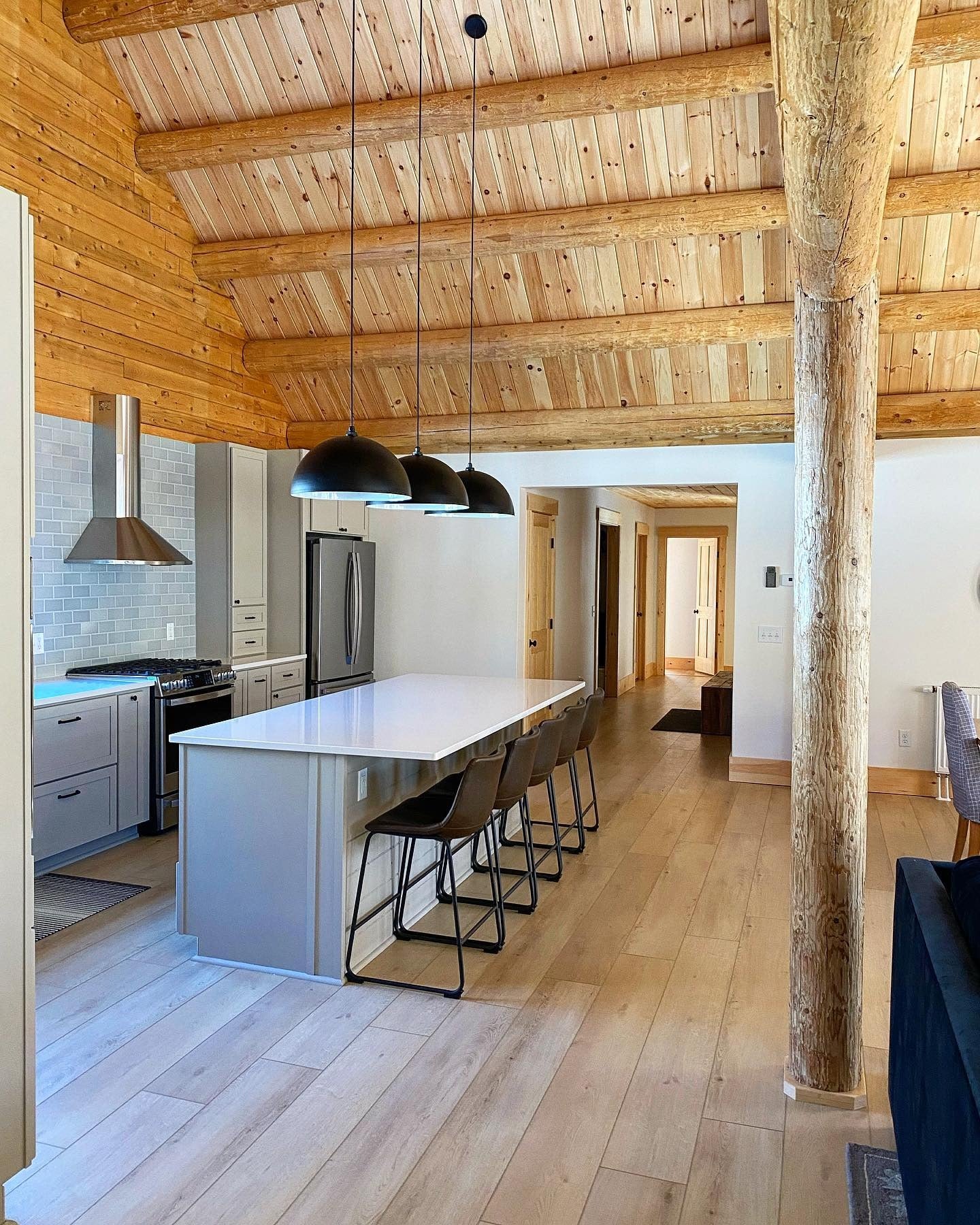 12. Light Gray Log Kitchen with Extended Island Seating (Log House Kitchen Ideas)