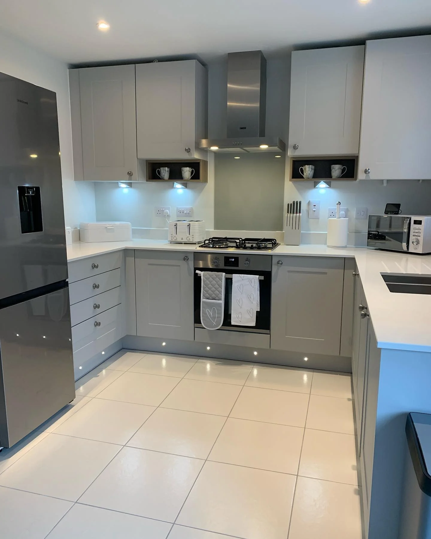 9. Contemporary Grey Kitchen with High-Gloss White Flooring (White Floor Kitchen Ideas)