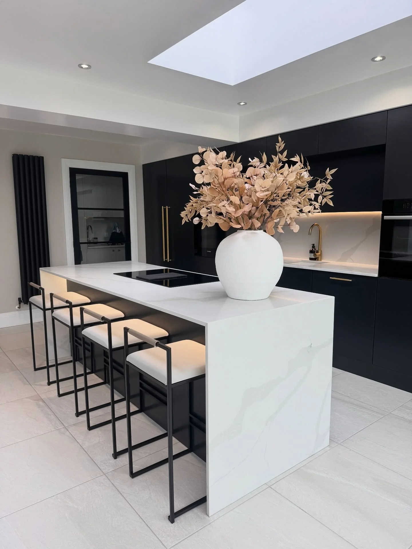 12. Matte Black Kitchen with Soft White Tiled Flooring (White Floor Kitchen Ideas)