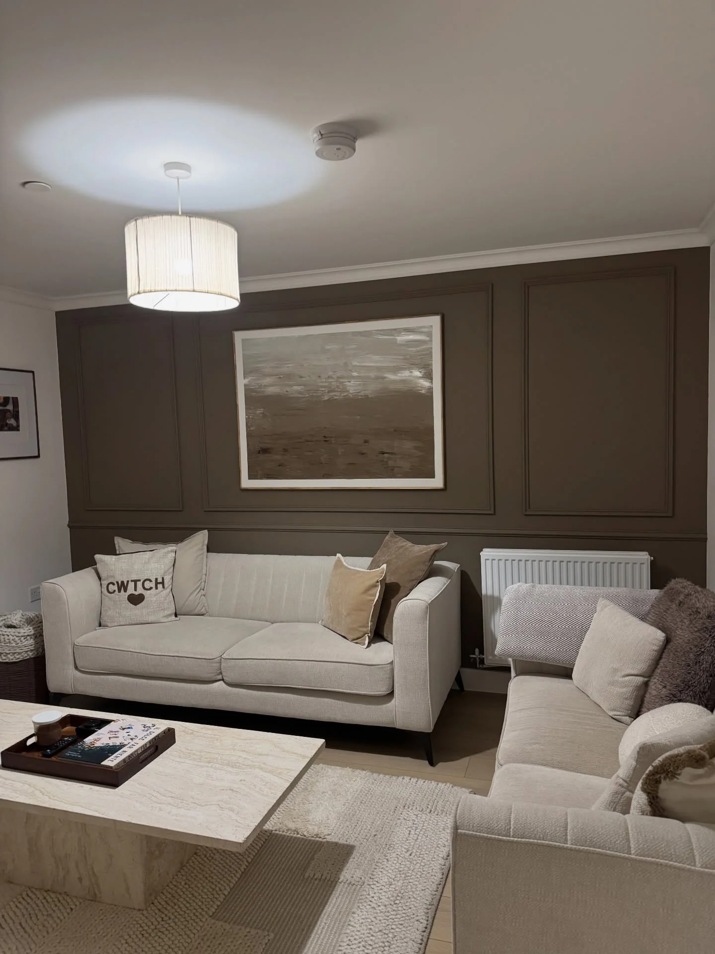 5. Mocha Accent Wall with Cream Upholstery (Cream and Brown Living Room Ideas)