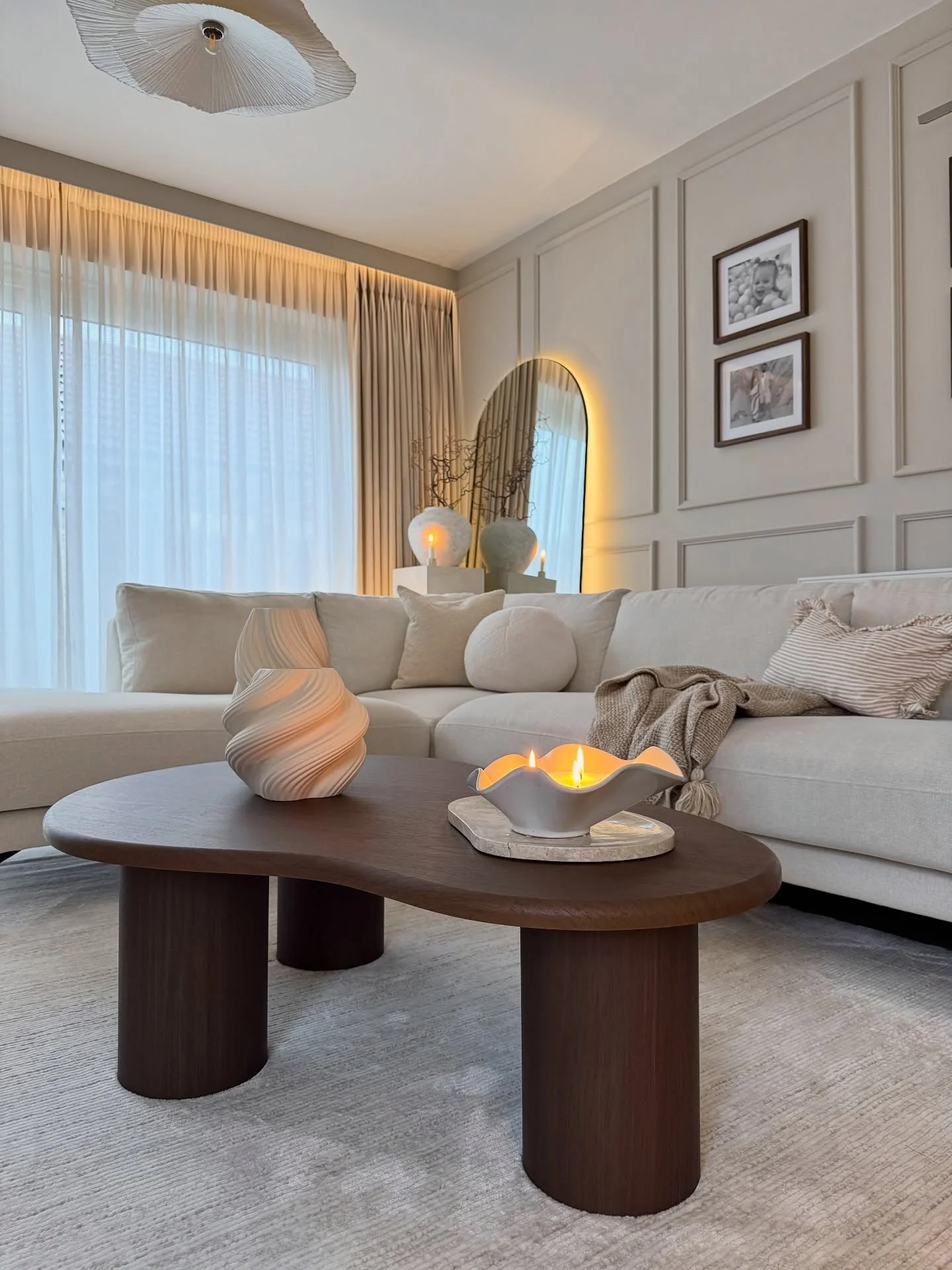 4. Modern Cream Sectional with Warm Wood Styling (Cream and Brown Living Room Ideas)