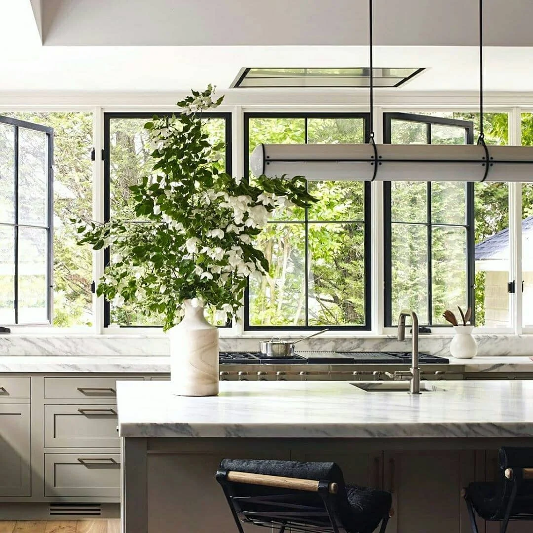 4. Soft Gray Cabinetry + Marble Counters + Black Windows (Stone + Ink Palette) (Earthy Kitchen Ideas)