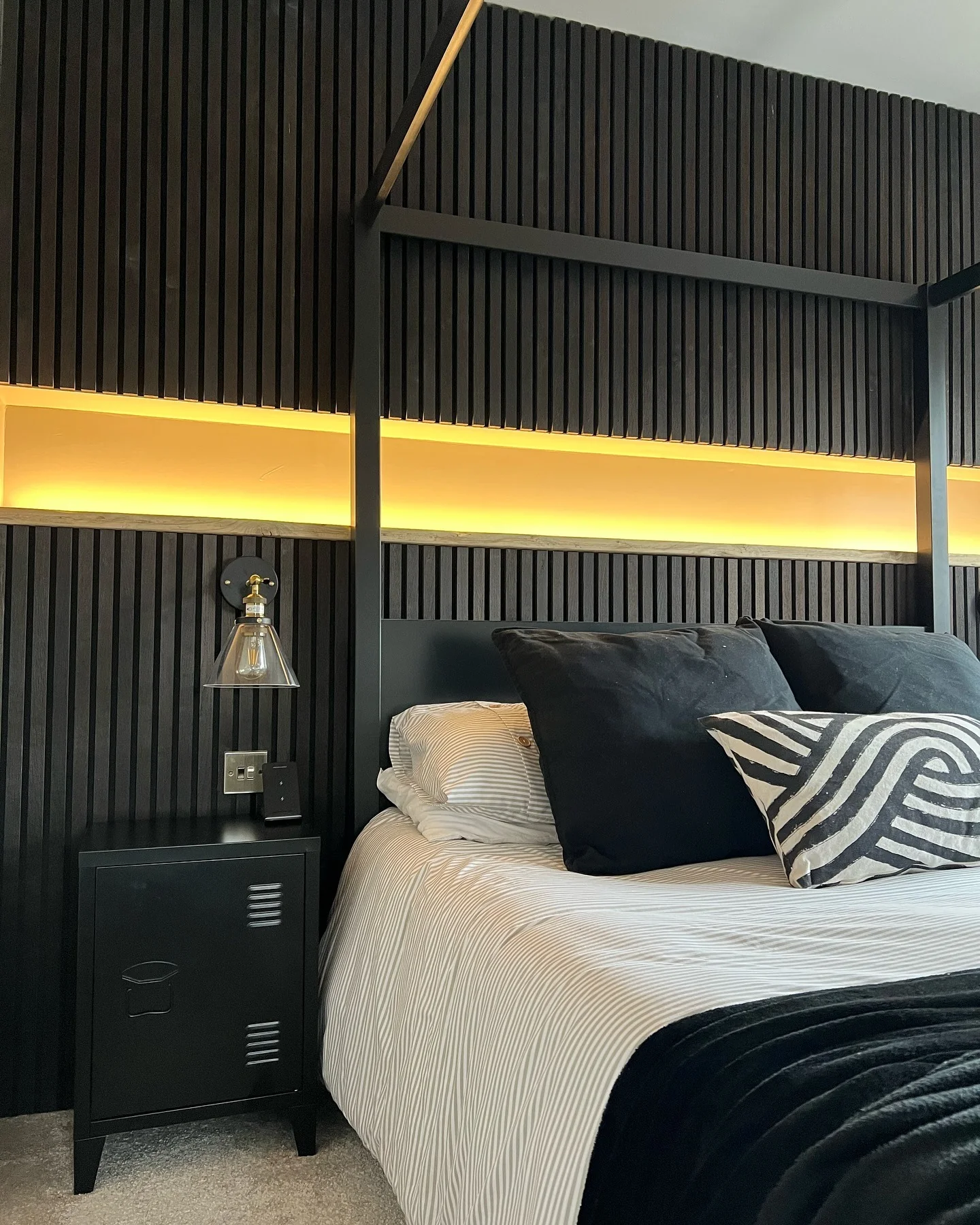 6. Acoustic Slat Wall + Soft LED Glow Bedroom (All Black Bedroom Ideas)