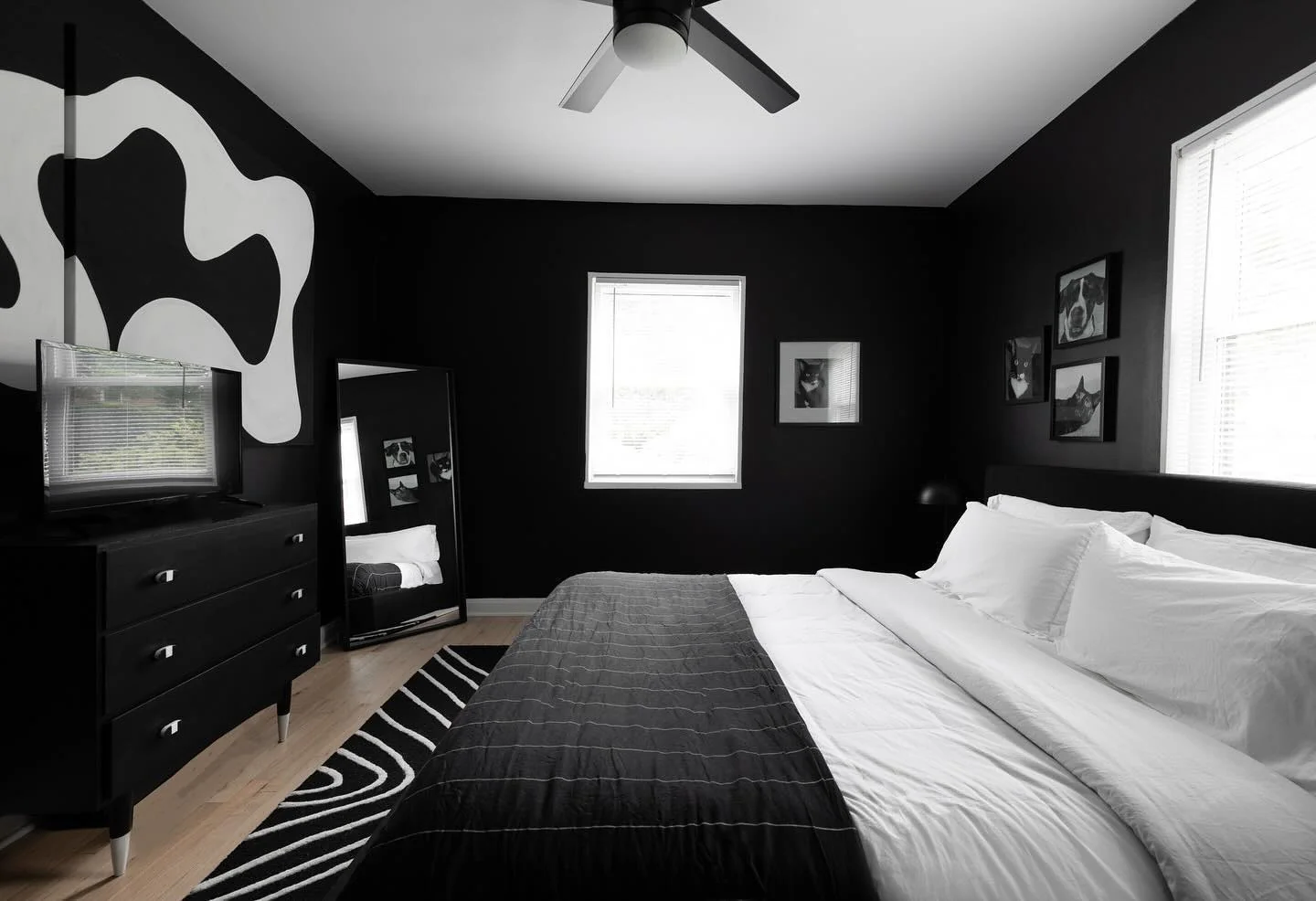 13. Modern Black Minimal Bedroom with White Bedding + Statement Wall Art (All Black Bedroom Ideas)