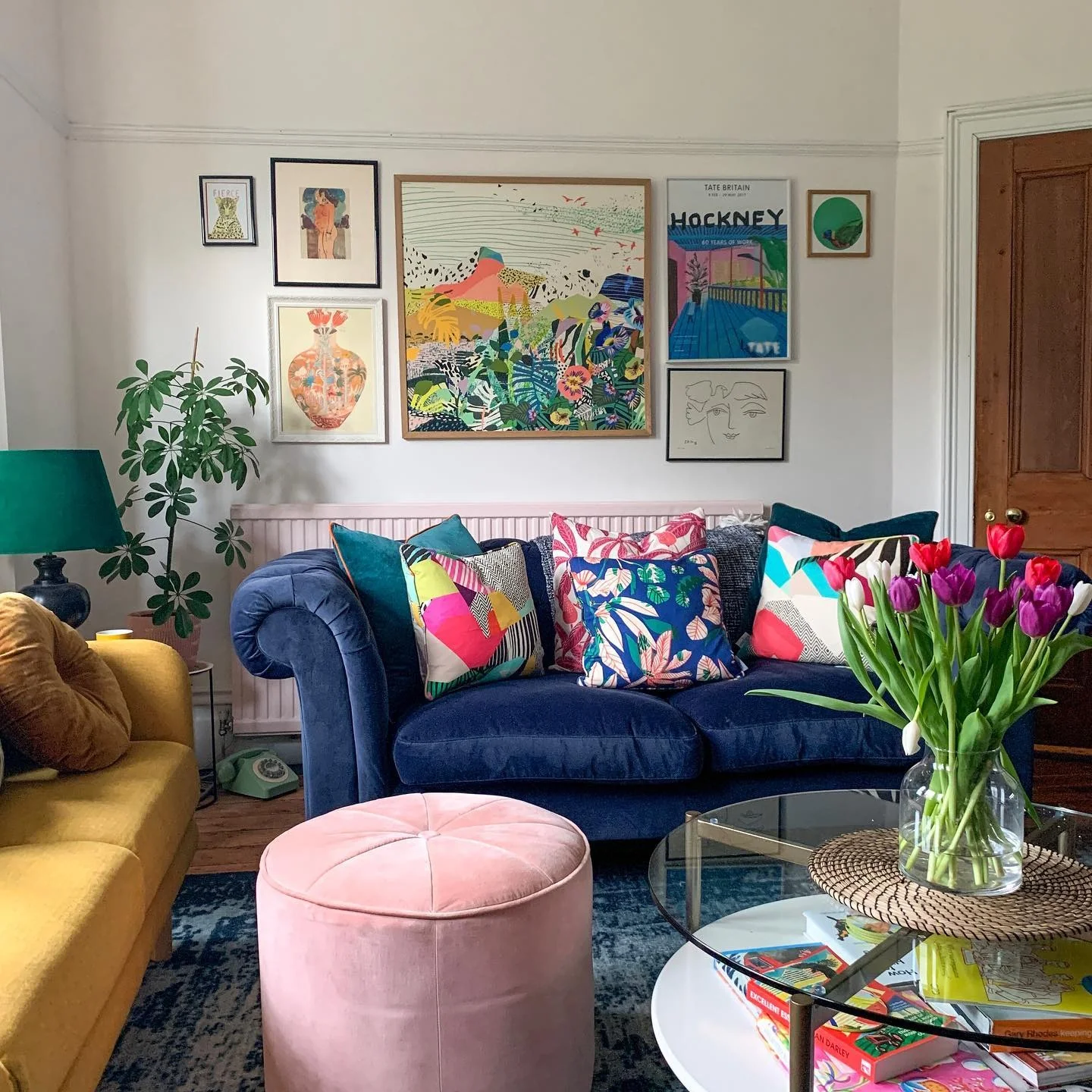 2. Playful Gallery Wall Mix with Royal Blue + Mustard + Pink (Royal Blue Sofa Living Room Ideas)