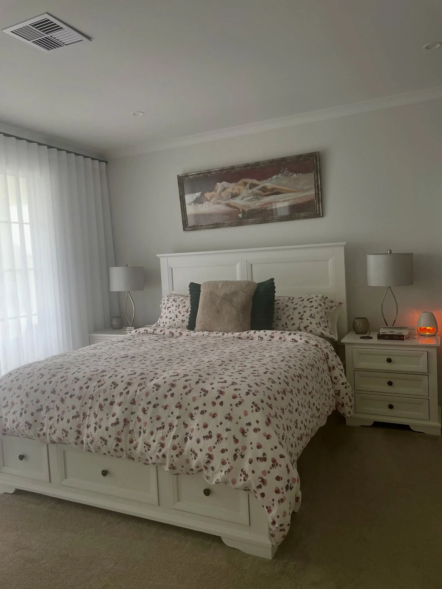 15. White Storage Bed with Patterned Bedding and Warm Accents (White Furniture Bedroom Ideas)