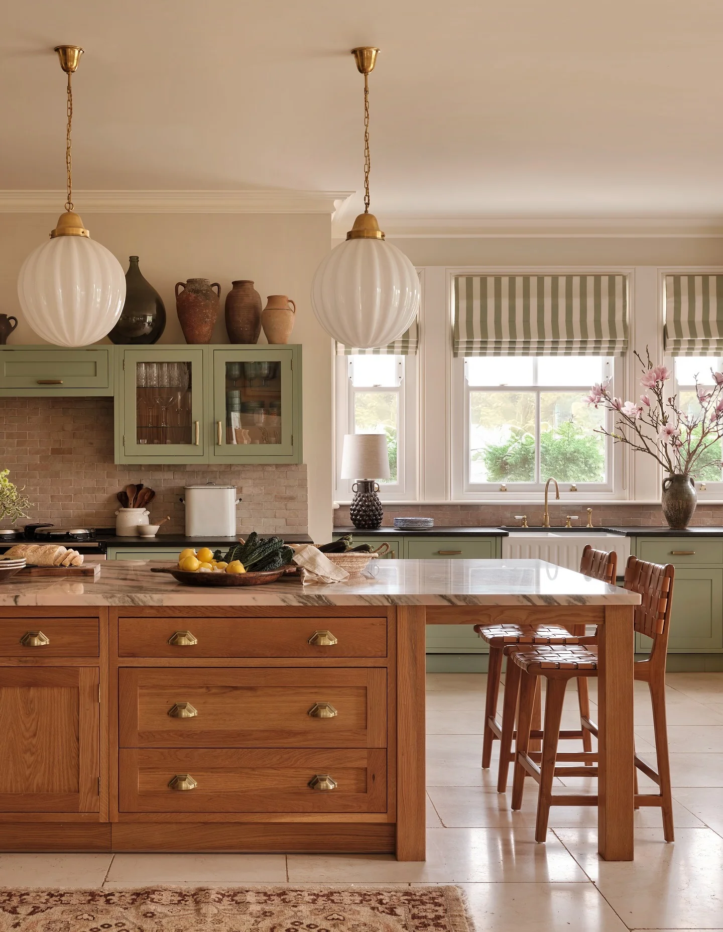 15. Spanish Country Kitchen with Green Cabinetry and Wood Island (Spanish Style Kitchen Ideas)