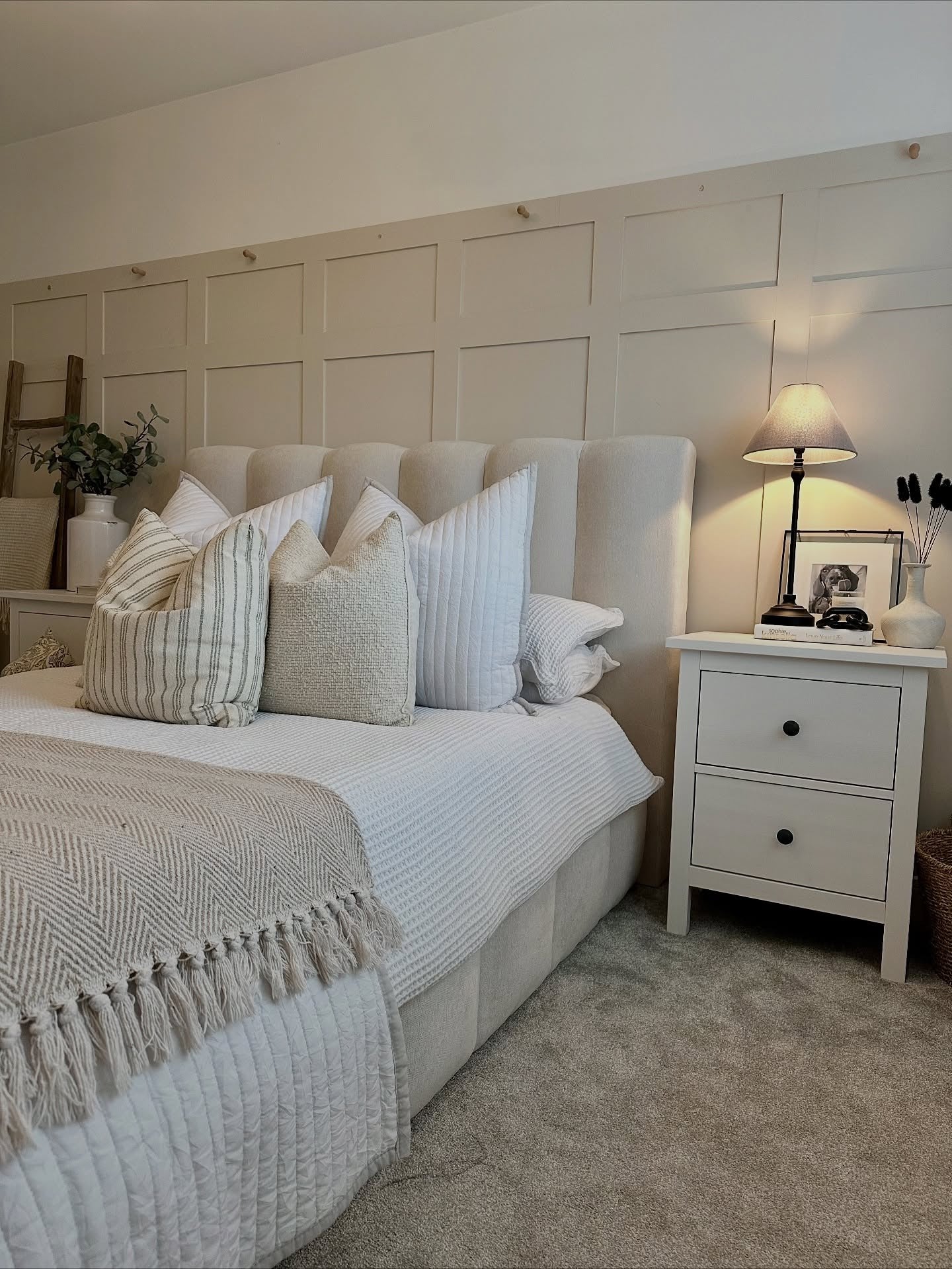 3. Warm White Paneling with Textured Neutrals (Accent Wall in Bedroom Ideas)