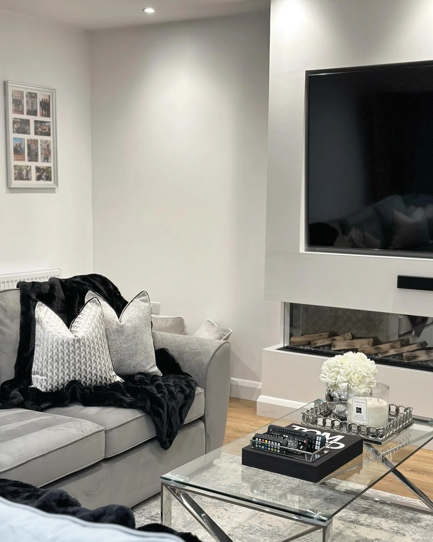 5. Sleek Grey Media Room with Glass and Chrome Details (Grey Living Room Ideas)