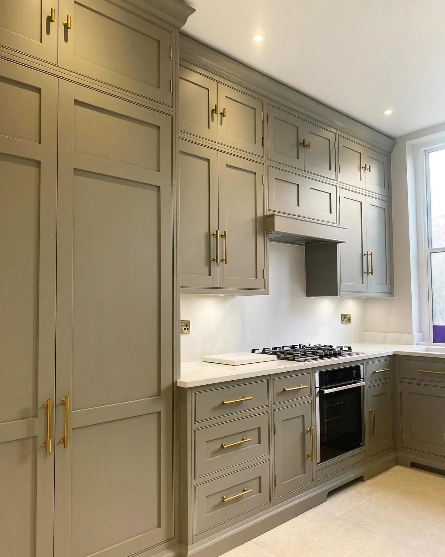 2. Classic Greige Tall Cabinetry with Brass Accents (Tall Kitchen Cabinets Ideas)